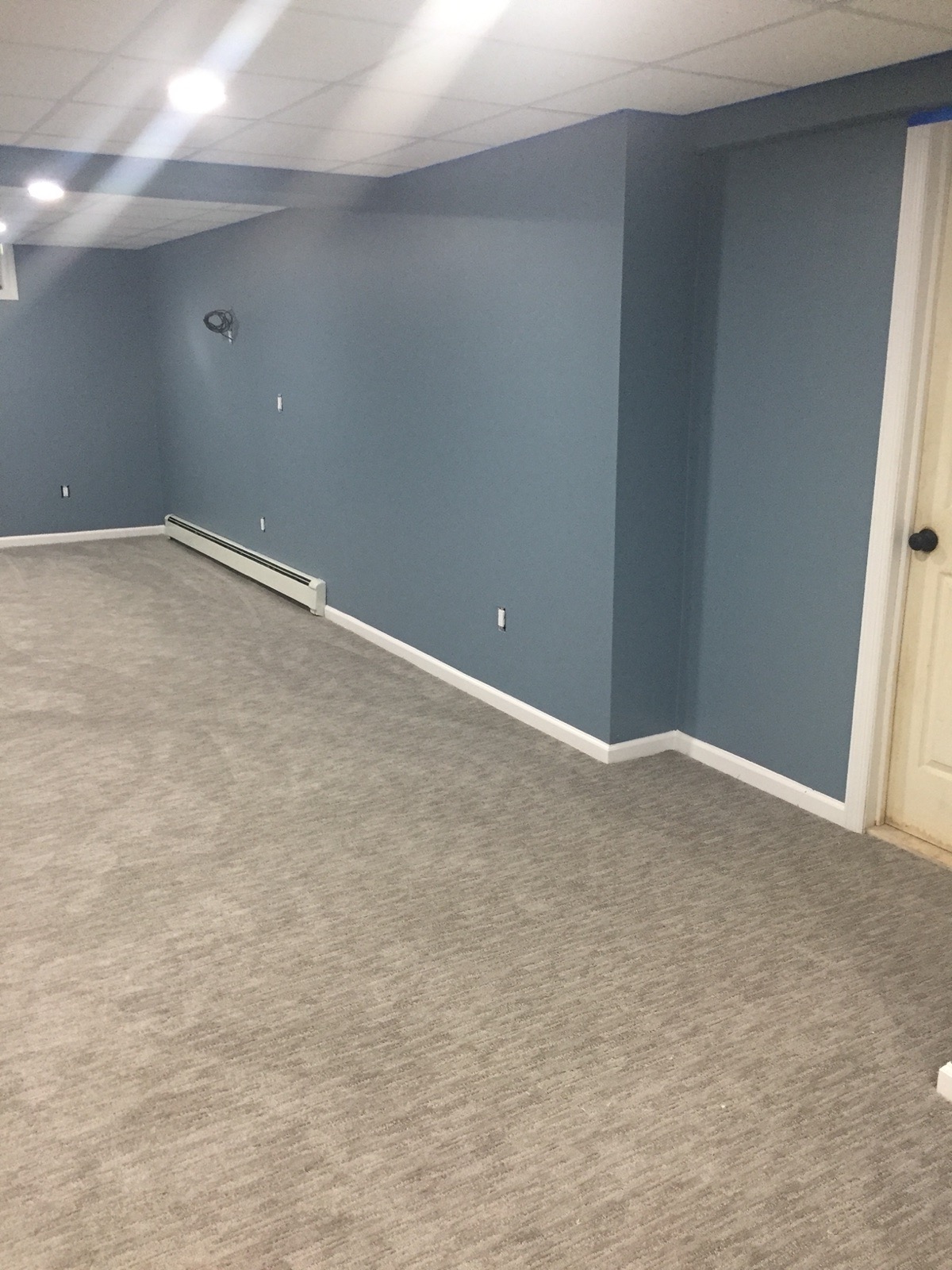 Finished basement with painted walls, new baseboard and wall to wall carpet